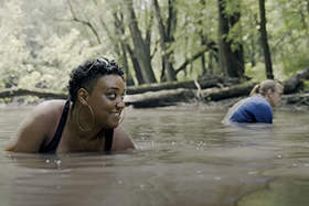 RiverWatch Volunteer Nina Carmichael hunts for mussels in the Sangamon River. This screenshot was taken from the film “Mussel Grubbing,” which will open the World Water Film Festival in New York this month.