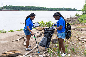 Xyla Nixon and TRIO classmate take part in a litter clean up along the banks of the Mississippi River. Photo by Route 3 Films.